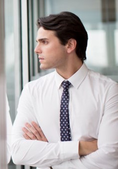 Businessman looking out office window